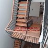 Cầu thang xương cá đôi bản thép 10mm mặt bậc gỗ gõ đỏ